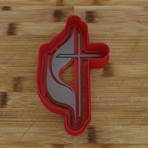 May include: Red plastic cookie cutter shaped like the Christian symbol of a flame and cross.