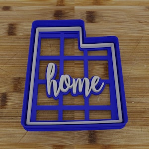 May include: Blue plastic cookie cutter shaped like the state of Utah with the word "home" cut out in the center.