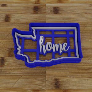 May include: Blue plastic cookie cutter shaped like the state of Washington with the word "home" inside.