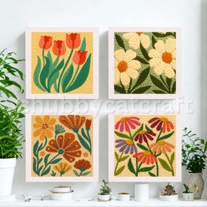 May include: Four framed floral art pieces. Each square features a different flower design in vibrant colors: red tulips, white daisies, orange and brown flowers, and multi-colored daisies. The background is a textured yellow.