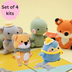 May include: Set of four crochet amigurumi kits featuring a gray elephant, orange fox, green dinosaur, and blue penguin. Each kit includes yarn, stuffing, and instructions.