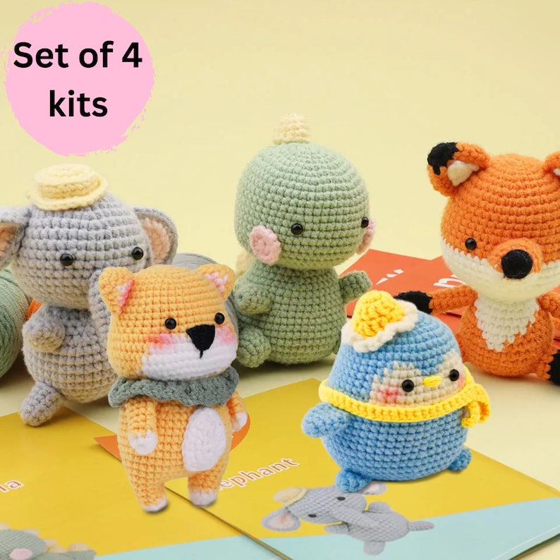 May include: Set of four crochet amigurumi kits featuring a gray elephant, orange fox, green dinosaur, and blue penguin. Each kit includes yarn, stuffing, and instructions.
