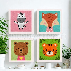 May include: Four framed animal portraits: a zebra on pink, a fox on teal, a bear on green, and a tiger on green. Each animal is depicted with a friendly, cartoon-like style. The frames are white, and the artwork is displayed on a white wall.