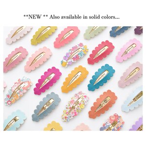 May include: Assortment of colorful hair clips with scalloped edges. Some clips feature floral patterns, while others are solid colors. **NEW** Also available in solid colors.