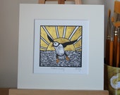 Puffin away - original, hand painted, mounted linocut print of a puffin at sunset