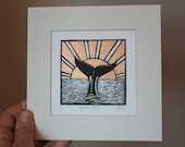 Into the deep - original, hand painted, mounted linocut print of a whale's tail as it dives into the sea at sunset