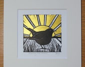 Blackbird at sunrise, original, hand coloured, mounted lino print