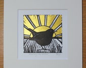 Morning has broken - original, hand painted, mounted linocut print of a blackbird at sunrise