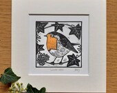 Winter robin, original, hand coloured, mounted lino print