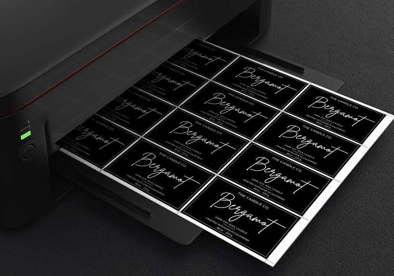 May include: A sheet of black and white labels with the text "THE CANDLE CO. Bergamot 100% Soy Wax Candle Created With Love In California" printed on each label.