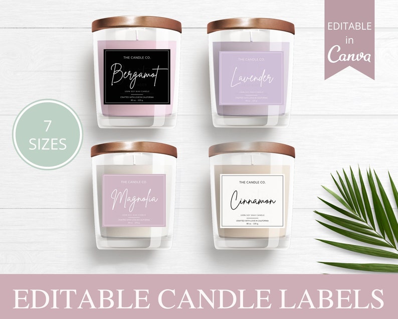 May include: Four candle jars with labels featuring different scents: Bergamot, Lavender, Magnolia, and Cinnamon. The labels are white with black text and a pink background. The jars are clear glass with gold lids. The image is on a white wood background with a green palm leaf in the corner.