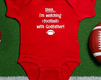 Shhh... I'm Watching Football With Godfather Color Baby Bodysuit, Fall Infant Pregnancy Announcement, Sports Fan Themed Baby Shower Gift