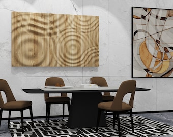 May include: A modern dining room with a black table and four brown chairs. The table is set with a white tablecloth and a glass vase with flowers. There are two abstract paintings on the wall behind the table.