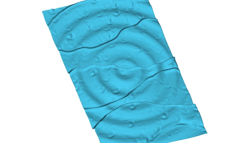 May include: A blue textured fabric with a repeating pattern of small circles. The fabric is folded in thirds and has a wavy, rippled texture.