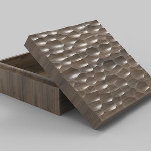May include: A wooden box with a textured lid, partially open. The lid's surface has a repeating pattern of rounded shapes. The box and lid are a medium brown color, suggesting a natural wood grain. The box is rectangular.