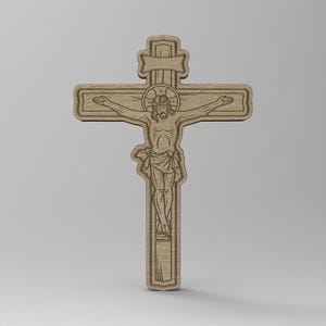 May include: A wooden crucifix featuring a detailed carving of Jesus Christ. The cross is made of light-colored wood and has a decorative border. The figure of Jesus is depicted with outstretched arms and a halo. The design is intricate and detailed.