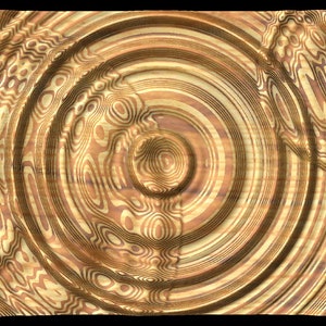 Puede incluir: Patr&oacute;n abstracto de c&iacute;rculos conc&eacute;ntricos en tonos dorados y marrones. El patr&oacute;n se asemeja a la veta de la madera con un efecto 3D.