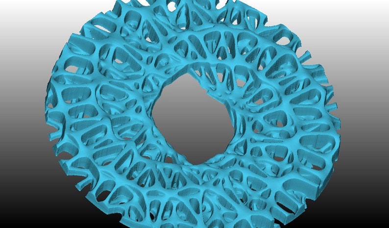 May include: A turquoise blue, 3D printed, circular object with a large hole in the centre. The object has a complex, intricate, and organic design that resembles a coral reef.