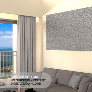 May include: A gray wall art panel with a textured, geometric pattern hangs above a gray sectional sofa. The image also shows a window with a view of a mountain range and the text "STL FILE FOR CNC".