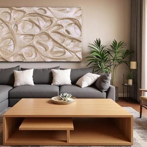 May include: A contemporary living room with a large grey corner sofa, white cushions, and a wooden coffee table. A decorative wall art piece hangs above the sofa. A tall green plant and a wooden chair are also present.