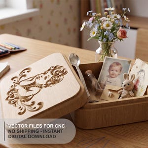 May include: A light-colored wooden keepsake box with a carved floral design on the lid. The open box contains a silver spoon, a small glass vial, a photograph of a child, a small envelope, and a crocheted rabbit toy. Text reads: VECTOR FILES FOR CNC NO SHIPPING - INSTANT DIGITAL DOWNLOAD.