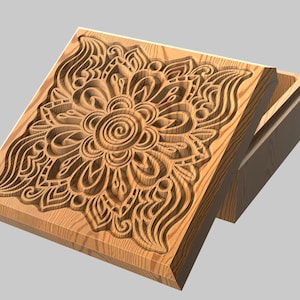 Könnte beinhalten: Holzkiste mit einem geschnitzten Blumendesign auf dem Deckel. Der Deckel ist leicht geöffnet und gibt den Blick ins Innere frei. Die Kiste ist aus hellem Holz gefertigt und weist aufwendige Details auf. Das Blumenmuster ist zentriert und von fließenden Linien umgeben.