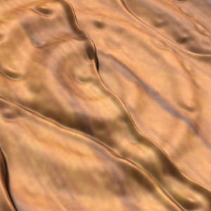 May include: A close-up of a textured, metallic surface with a warm, golden brown color. The surface has a rippled, wavy pattern, creating a sense of movement and depth.