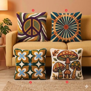 May include: Four decorative throw pillows with colorful, textured designs. One features a peace sign, another a sunburst pattern, a third has a floral design, and the last displays mushrooms. The pillows are on a yellow sofa.