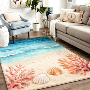 May include: A rectangular area rug featuring a coastal design with a sandy beach, turquoise ocean waves, white sea foam, two detailed seashells, and two large coral branches in shades of pink and orange printed across the surface.