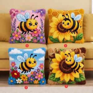 May include: Four decorative throw pillows with bee and flower designs. The pillows feature a variety of colorful floral backgrounds, including pink, yellow, and blue. Each pillow has a different bee design, with a cute, cartoonish appearance.