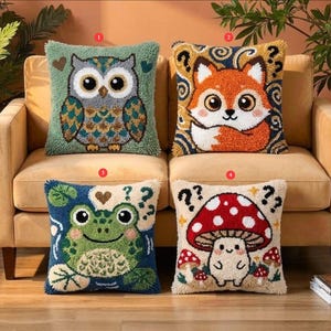 May include: Four square throw pillows featuring textured punch needle designs. The first shows a green owl, the second an orange fox, the third a green frog, and the fourth a red mushroom. Each pillow is numbered one through four in red circles.