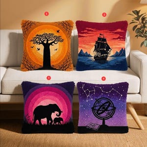 May include: Four square throw pillows with textured surfaces. Pillow 1 features a baobab tree against an orange sun. Pillow 2 shows a sailing ship on water at sunset. Pillow 3 depicts two elephants against a pink sun. Pillow 4 displays an armillary sphere.