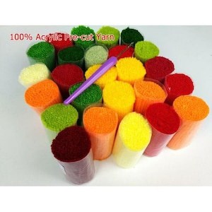 May include: A collection of 100% acrylic pre-cut yarn in various colors, including yellow, orange, red, green, and white. The yarn is wound around plastic spools and comes with a purple yarn needle.