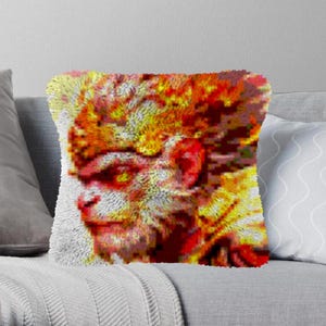 May include: A close-up of a colorful, pixelated image of a monkey's face. The monkey's fur is a mix of red, orange, and yellow, and its eyes are closed. The image is reminiscent of a mosaic or a pixelated art style.