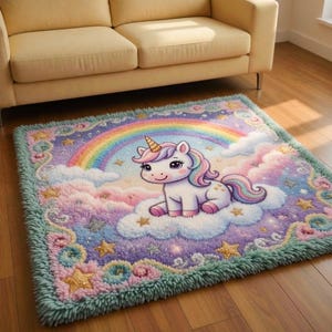 May include: A rectangular rug featuring a cartoon unicorn sitting on a cloud with a rainbow in the background. The rug has a fluffy texture with a green border, and is decorated with stars and pastel colors.