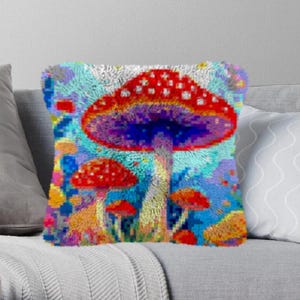 May include: A colorful psychedelic mushroom pillow with a red and white cap, a purple stem, and a blue background. The pillow is decorated with other mushrooms in various colors and sizes.