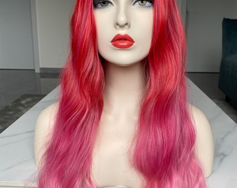 May include: A long, wavy wig with a pink to red ombre color. The wig is styled with loose waves and is worn on a mannequin head.