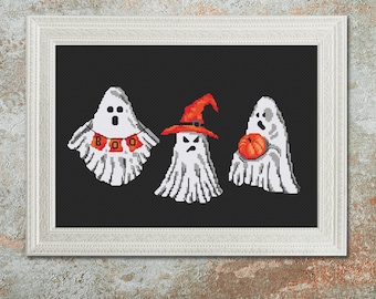 May include: Cross stitch pattern featuring three ghosts on a black background. One ghost is wearing a witch's hat, another is holding a pumpkin, and the third has a "BOO" banner.