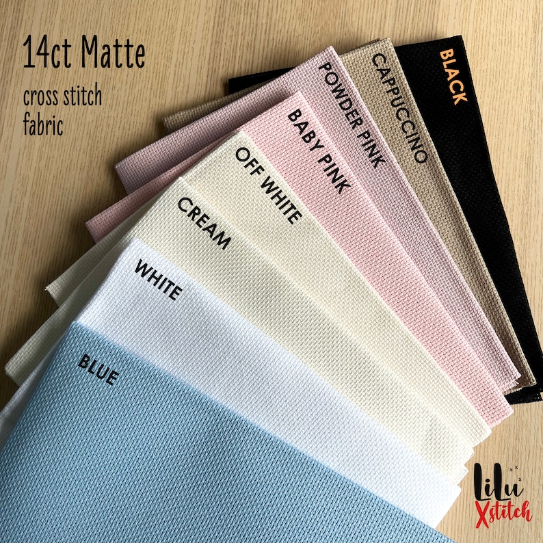 May include: A variety of 14 count Aida cloth fabric swatches in colors including black, cappuccino, powder pink, baby pink, off white, cream, white, and blue. The fabric is labeled "14ct Matte cross stitch fabric".