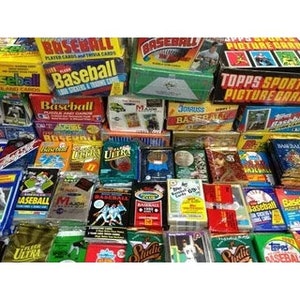 May include: A collection of unopened and opened packs of baseball trading cards. The packs are from various brands, including Topps, Ultra, and others. The packs are in various colors and designs.