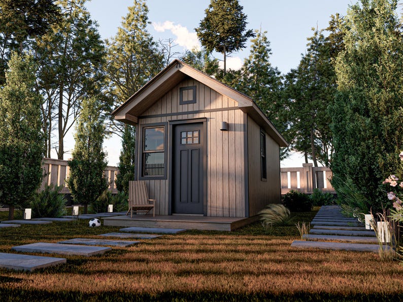 May include: A small wooden cabin with a gray door and a window. The cabin is surrounded by trees and grass.
