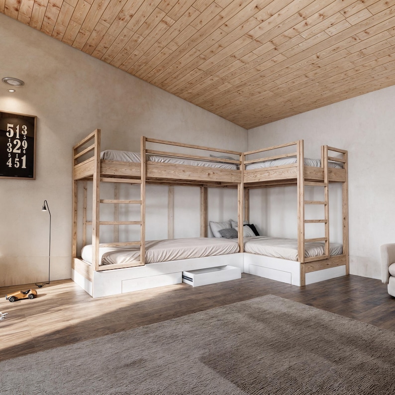 May include: A set of wooden bunk beds with white drawers underneath. The beds are arranged in an L-shape and have a natural wood finish.