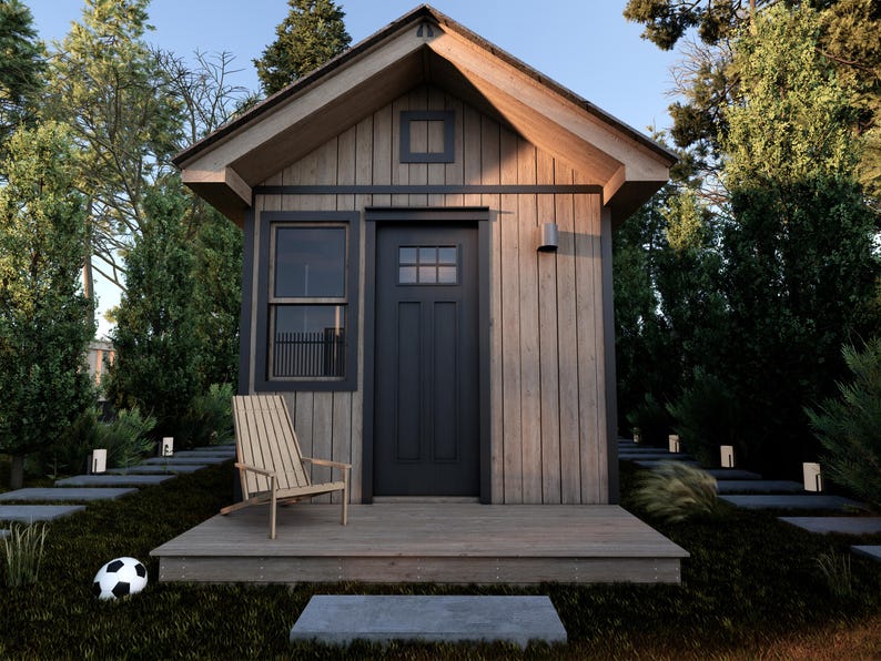 May include: A small wooden cabin with a black door and windows. The cabin has a wooden porch with a wooden chair and a soccer ball on the ground in front of it.