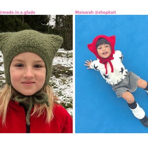 May include: Two children wearing cat-eared hats. One hat is olive green, the other is red. The child on the left is wearing a red jacket. The child on the right is wearing a white sweater with black star designs, a grey skirt, and black shoes.