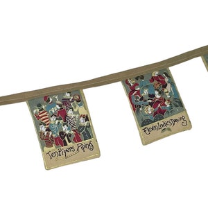 May include: A Christmas-themed fabric banner with illustrations of the 12 Days of Christmas. The banner features four flags with the following text: "Nine Drummers Drumming", "Ten Pipers Piping", "Eleven Ladies Dancing", and "Twelve Lords a Leaping".
