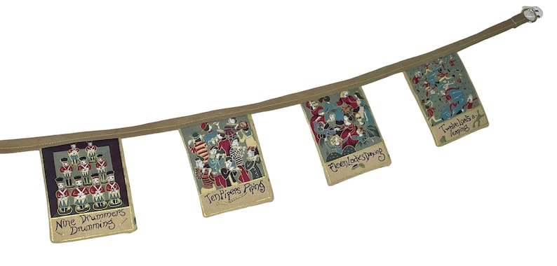 May include: A Christmas-themed fabric banner with illustrations of the 12 Days of Christmas. The banner features four flags with the following text: "Nine Drummers Drumming", "Ten Pipers Piping", "Eleven Ladies Dancing", and "Twelve Lords a Leaping".
