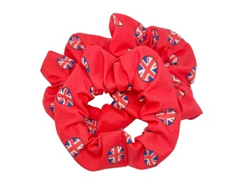 May include: Red scrunchie with a repeating pattern of the Union Jack flag.