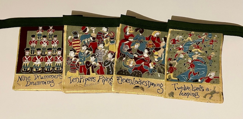 May include: A set of four fabric banners with illustrations of the 12 Days of Christmas. Each banner features a different verse of the song, with colorful illustrations of the gifts. The banners are sewn together with green ribbon.