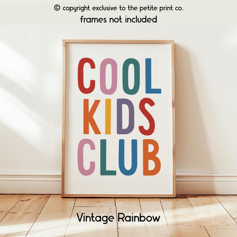 May include: A rectangular wall art print featuring the text COOL KIDS CLUB in large, multi-colored sans-serif letters. The letters are colored in red, pink, teal, blue, orange, and purple. The print is displayed in a light wood frame.