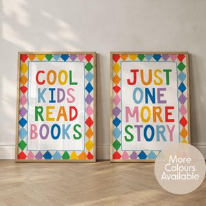 May include: Two rectangular wall art prints in wooden frames. The left print features the text COOL KIDS READ BOOKS in multicoloured letters. The right print features the text JUST ONE MORE STORY in multicoloured letters. Both have diamond borders.